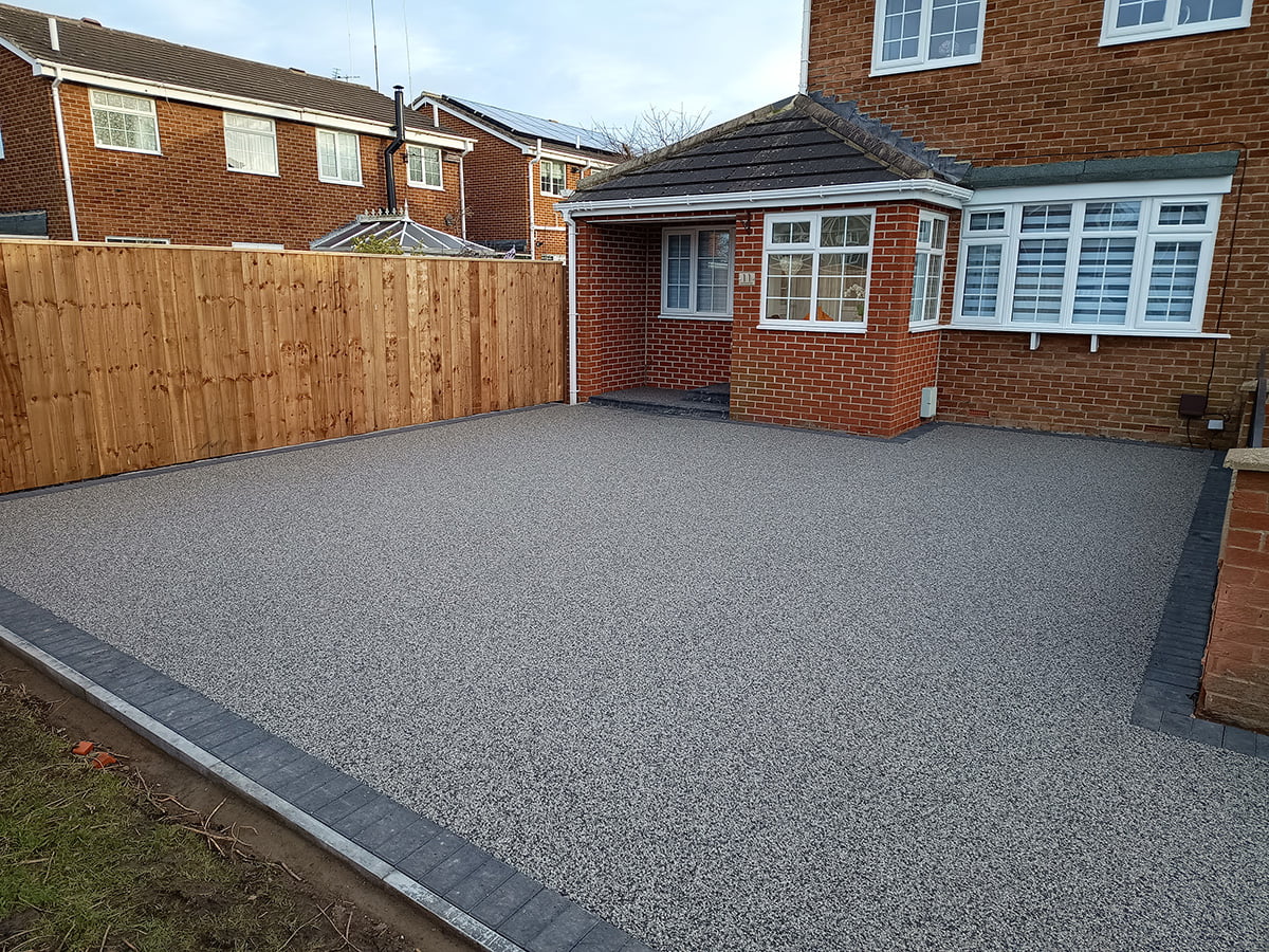 **6. Quick Installation**: Our efficient installation process minimises disruption to your daily routine, allowing you to enjoy your new Resin Bound Driveway in Wide Open in no time. With meticulous attention to detail, we ensure a flawless finish that exceeds your expectations. **7. UV Stability**: Rest assured that your Resin Bound Driveway will maintain its vibrant colour and appearance, even under prolonged exposure to sunlight. Our UV-stable resin formulations resist fading, ensuring long-lasting beauty for your home in Wide Open. **8. TrustMark Certified Craftsmanship**: As TrustMark-certified specialists, we adhere to the highest standards of quality and professionalism in every project we undertake in Wide Open, Tyne and Wear. Your satisfaction is our top priority, and we strive to exceed your expectations at every step of the process. With our focus on quality craftsmanship and customer satisfaction, we take pride in delivering exceptional results for homeowners in Wide Open and beyond. Experience the beauty and durability of Resin Bound surfaces by contacting us today. Let us bring your outdoor vision to life with our premium paving solutions.” Resin Bound Driveway New Hartley NE25