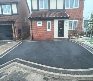 Tarmac driveway with two tone block paved border