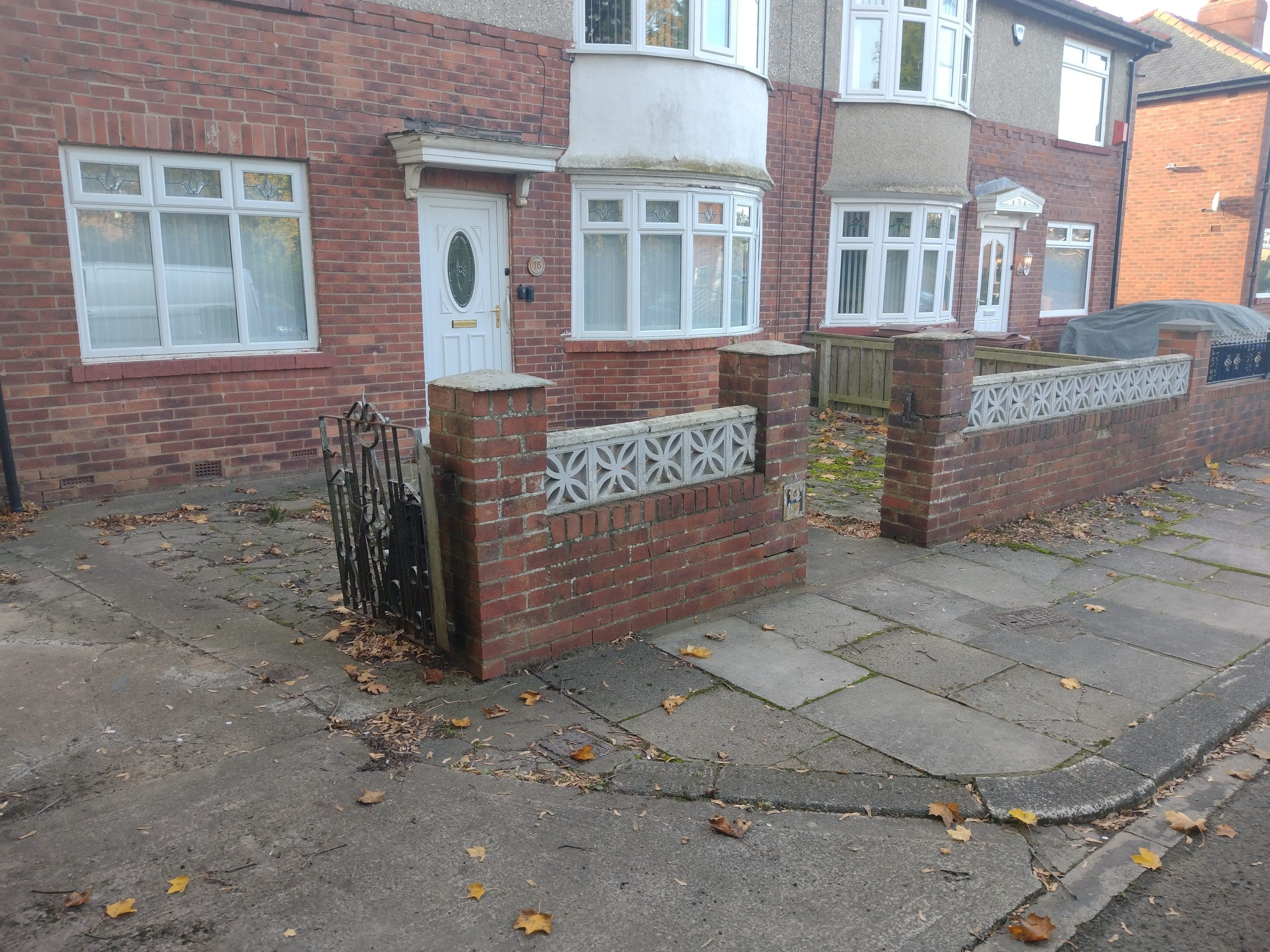 Tarmac driveway with a red brick border