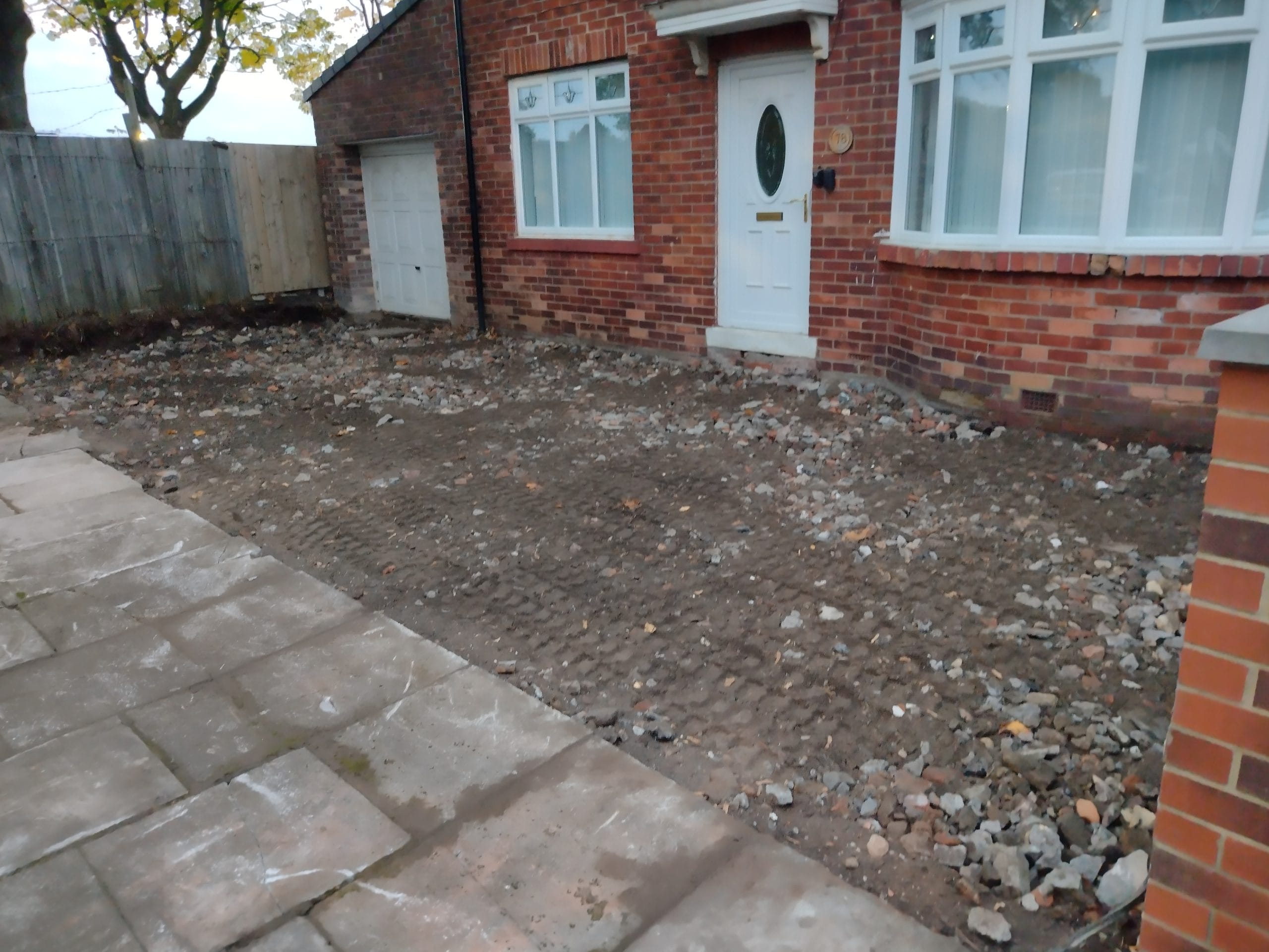 Tarmac driveway with a red brick border