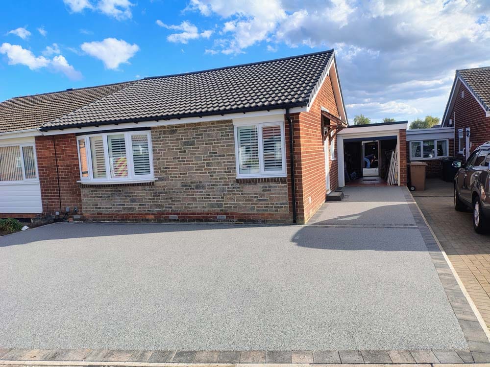 Daltex dark grey marble driveway with a granite border